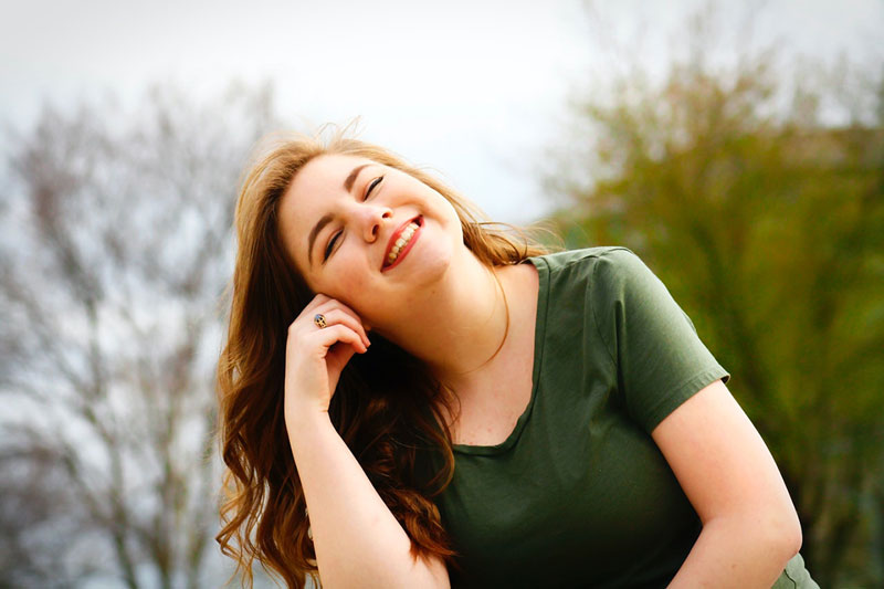 γυναίκα χαμογελάει και σκέφτεται την ντοπαμίνη το νευροδιαβιβαστή που έχει κερδίσει μία «μυθική» θέση στον εγκέφαλο