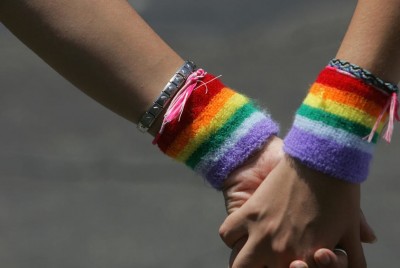 δύο χέρια με περικάρπια με τα χρώματα των ΛΟΑΤΚΙ