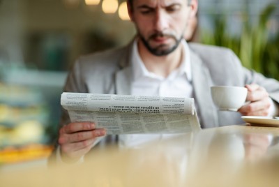 άνδρας διαβάζει προπαγάνδα στην εφημερίδα