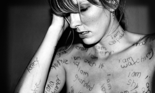 γυναίκα με λέξεις ζωγραφισμένες στο σώμα της